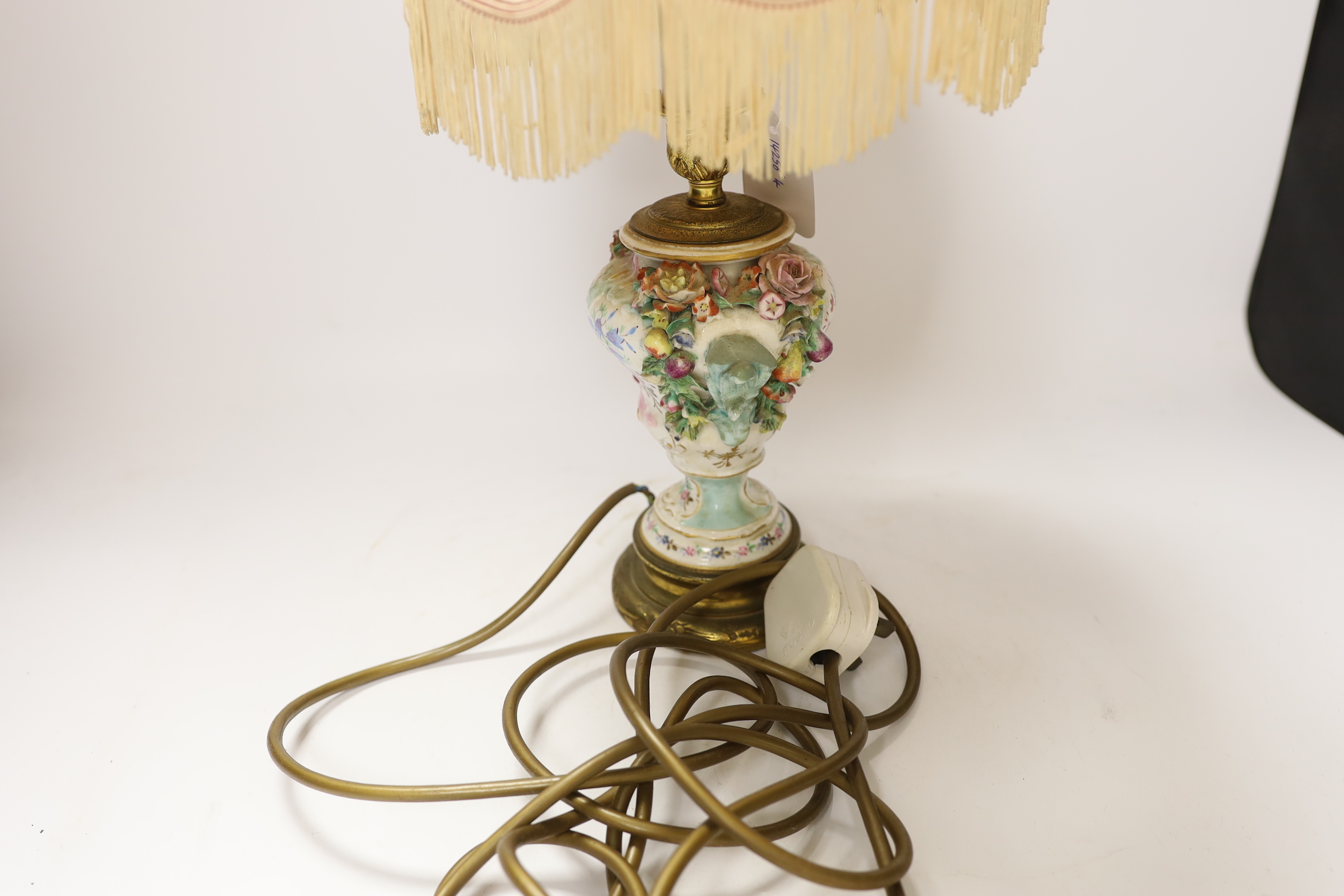 A 19th century floral encrusted table lamp with silk shade, 47cm high